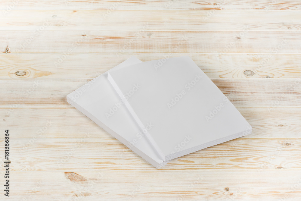 Mockup of magazine, poster, A4 brochure, catalog or flyer isolated on white wooden background. Blank page top view for use in design, mockups and simulations. Mockup of magazine, poster, A4 brochure, catalog or flyer isolated on white wooden background. Blank page top view for use in design, mockups and simulations.