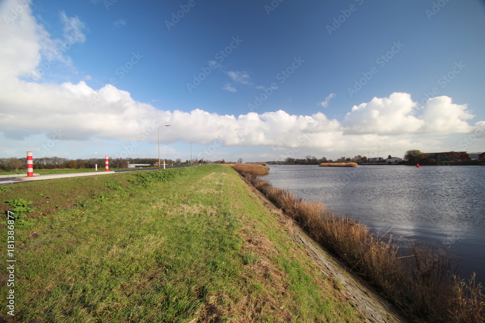 Wide angle overview of blue sky, white clouds and river Hollandse IJssel in Moordrecht, Netherlands Wide angle overview of blue sky, white clouds and river Hollandse IJssel in Moordrecht, Netherlands
