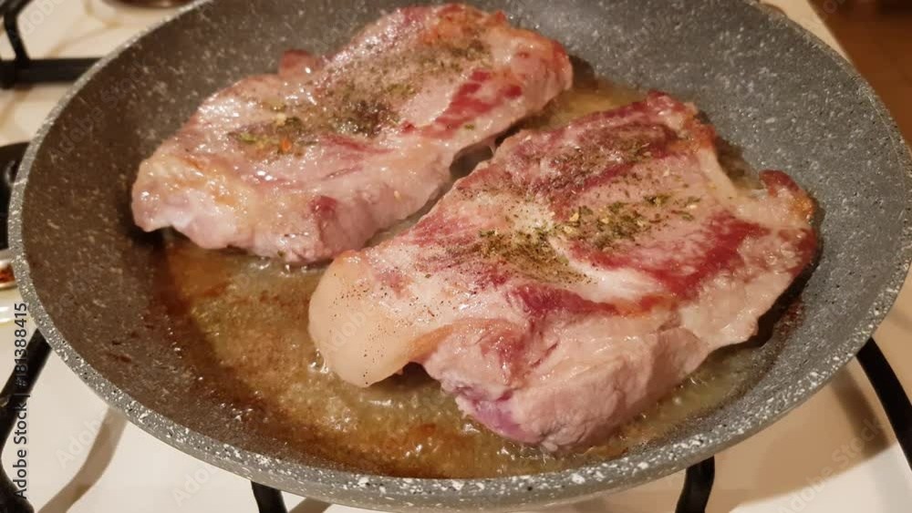 Juicy appetizing steaks from fat pork fried in a pan with olive oil
Juicy appetizing steaks from fat pork fried in a pan with olive oil
