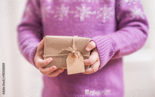 Young cild hands holding handmade gift box photo