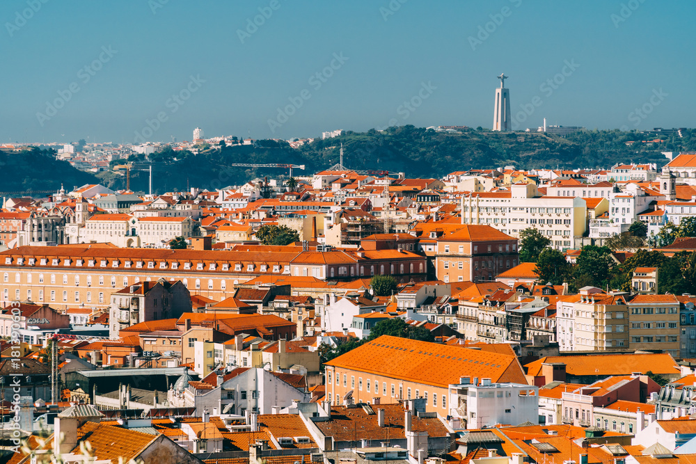 Aerial View Of Downtown Lisbon Skyline Of The Old Historical City And Cristo Rei Santuario (Sanctuary Of Christ the King Statue) In Portugal