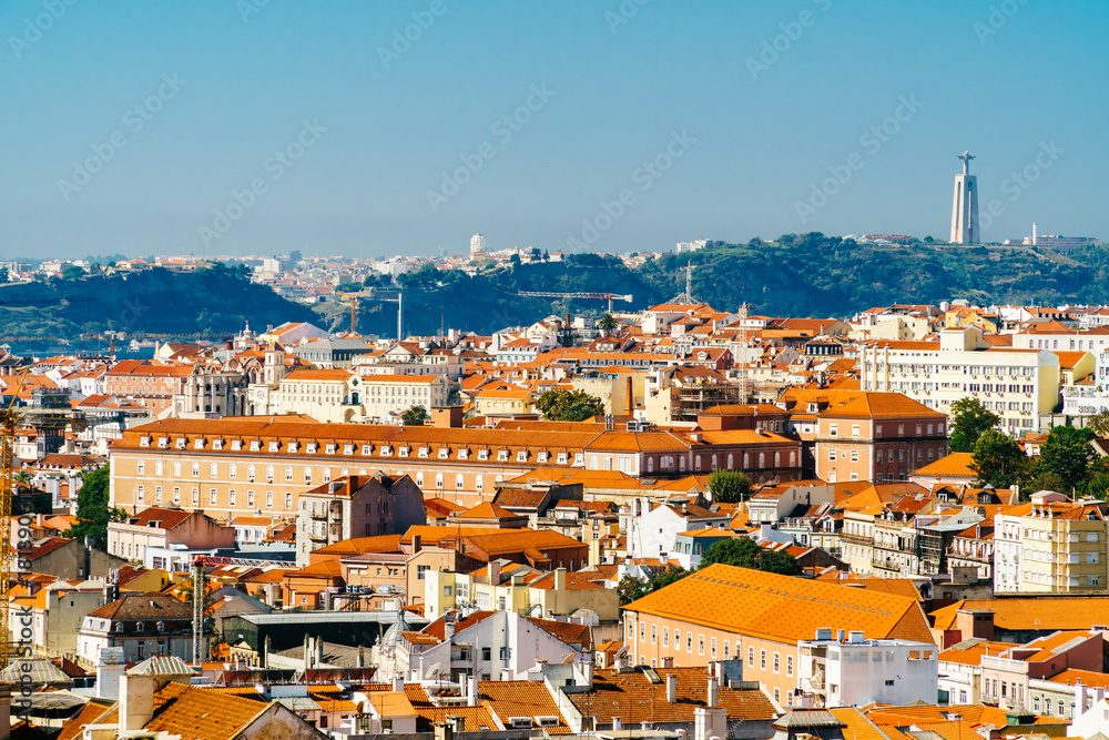 Aerial View Of Downtown Lisbon Skyline Of The Old Historical City And Cristo Rei Santuario (Sanctuary Of Christ the King Statue) In Portugal