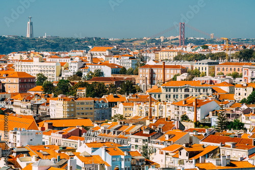 Aerial View Of Downtown Lisbon Skyline Of The Old Historical City And Cristo Rei Santuario (Sanctuary Of Christ the King Statue) In Portugal