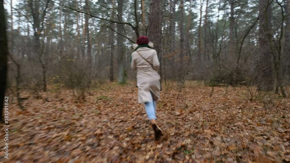 scared woman trying to escape running away from man chasing her in a forest scared woman trying to escape running away from man chasing her in a forest