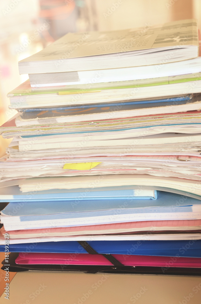 Fototapeta premium Pile of books and papers in the classroom