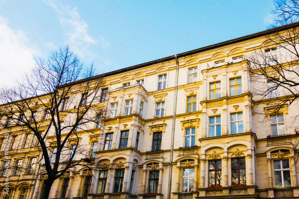 yellow houses in berlin with trees in the foreground at fall yellow houses in berlin with trees in the foreground at fall