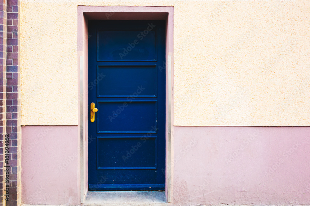 blue entrance door on orange building