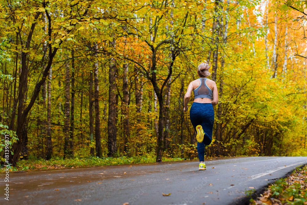 Woman running in the autumn park Woman running in the autumn park
