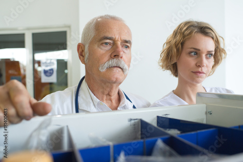 male doctor and female nurse in archives room