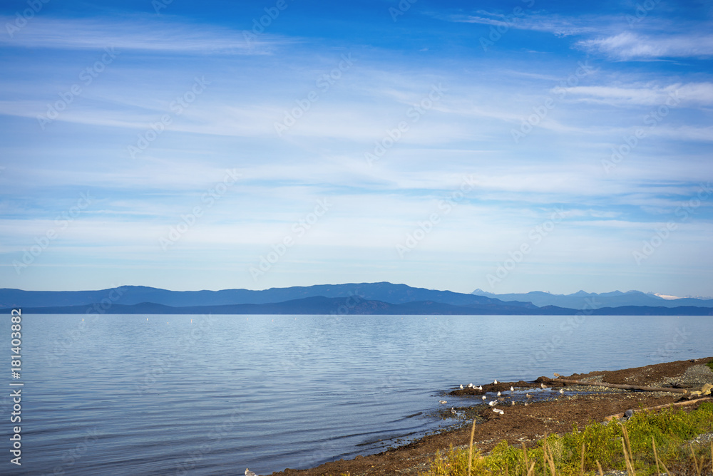 Qualicum beach in Vancouver Island, with the Canadian Rockies in the background, BC, Canada