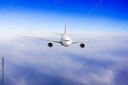 Fototapeta Naklejka Na Ścianę i Meble -  Aircraft is flying in blue cloudy sky. Airplane in the sky