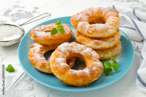 Homemade fried vanilla cottage cheese donuts on a white concrete background