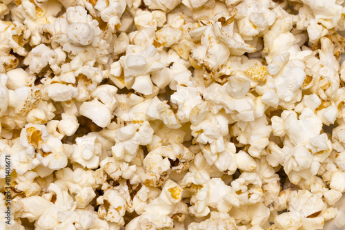 Scattered salted popcorn, texture background. Close up.The view from the top