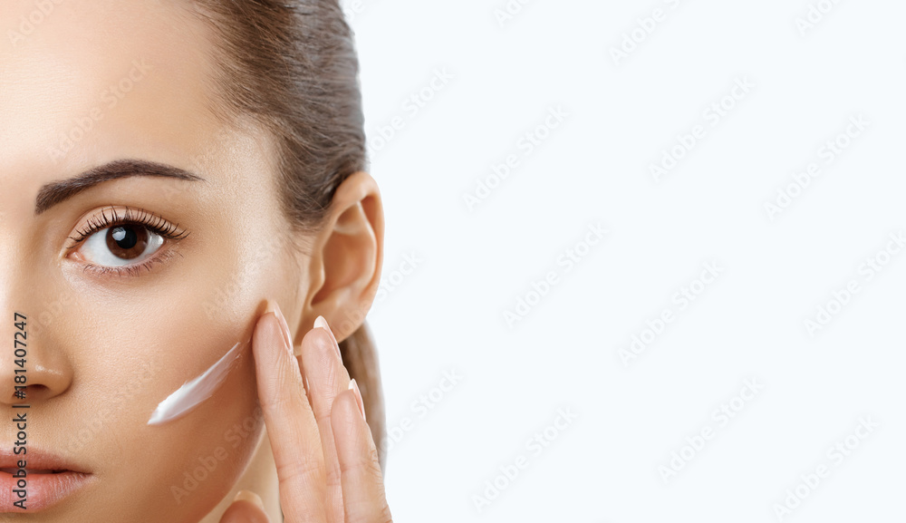 Facial Care. Female Applying Cream.Portrait Of Young Woman With Cosmetic Cream On Skin. Closeup Of Beautiful Girl With Beauty Product On Soft Skin, Natural Makeup Touching Face. High Resolution Facial Care. Female Applying Cream.Portrait Of Young Woman With Cosmetic Cream On Skin. Closeup Of Beautiful Girl With Beauty Product On Soft Skin, Natural Makeup Touching Face. High Resolution