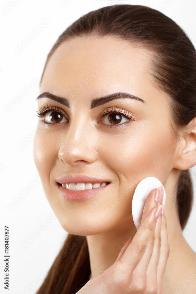 Skin Care. Beautiful Happy Woman Removing Face Makeup Using Cotton Pad. Closeup. Portrait Of Woman Smiling With Natural Makeup Touching Perfect Fresh Soft Skin, Cleaning Her Face.Beauty Face. Skin Care. Beautiful Happy Woman Removing Face Makeup Using Cotton Pad. Closeup. Portrait Of Woman Smiling With Natural Makeup Touching Perfect Fresh Soft Skin, Cleaning Her Face.Beauty Face.