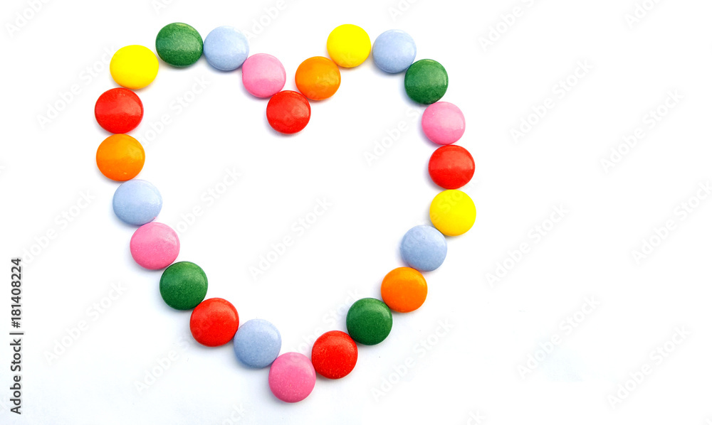 Heart from colorful chocolate candies  on white background