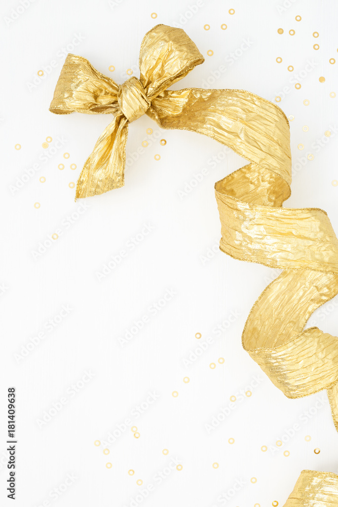 Golden Bow & decorative helix ribbon with gold tinsel on white. Vertical  Festive background. Holiday preparations, Boxing Day. Overhead view Stock  Photo | Adobe Stock