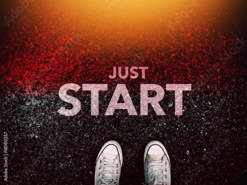 Just start word and sneakers shoes on grunge road and light effect photo