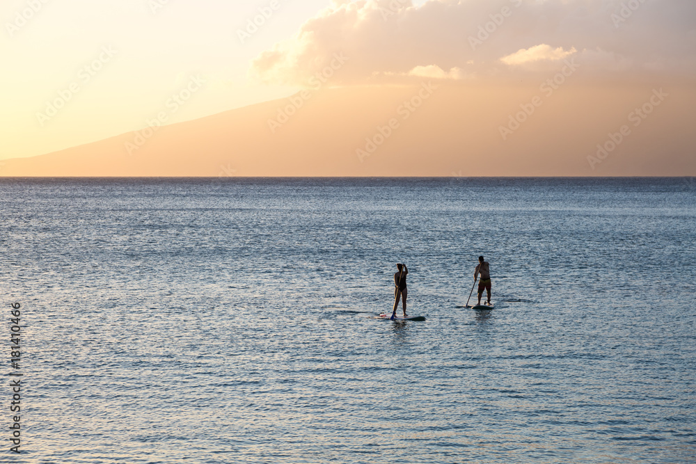 Silhouette of two standup paddlers on Maui, Hawaii