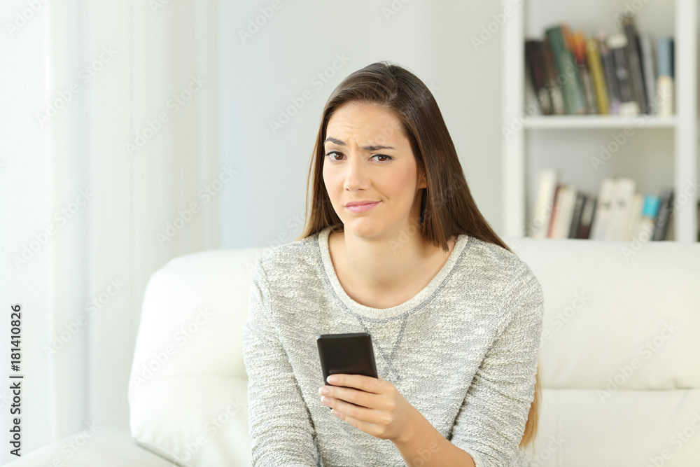 Suspicious woman holding phone looking at you Suspicious woman holding phone looking at you