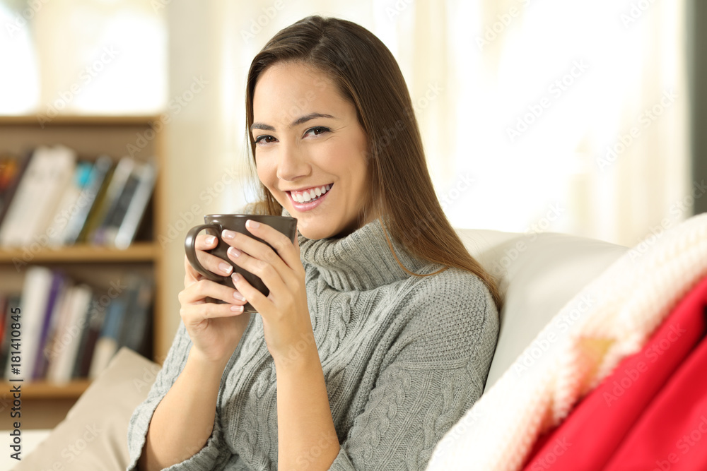 Woman posing holding a coffee mug in winter Woman posing holding a coffee mug in winter