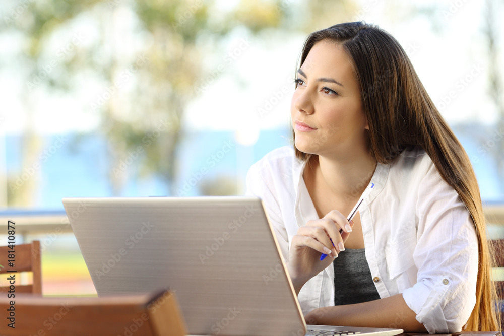 Woman wondering working on a beach apartment Woman wondering working on a beach apartment