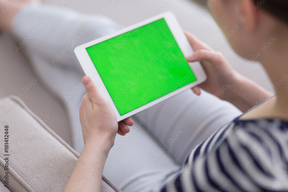 woman on sofa using tablet computer woman on sofa using tablet computer
