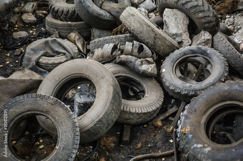 Heap of old car junk tires, used truck rubbish wheels, industrial garbage