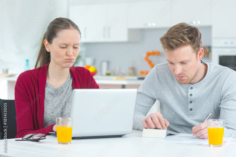 young couple studying with having breakfast young couple studying with having breakfast