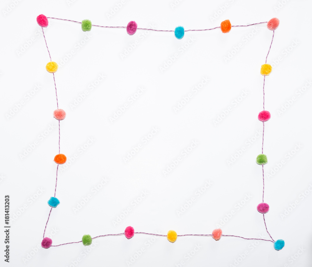 Pom Poms in a Curvilinear Square against a white background. Photographed at eye level. Pom Poms in a Curvilinear Square against a white background. Photographed at eye level.