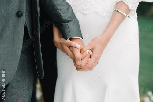 newly married couple Groom and Bride together holding hands on ceremony