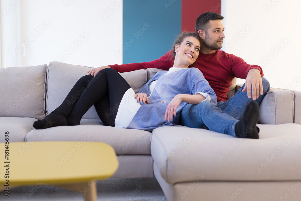 couple hugging and relaxing on sofa couple hugging and relaxing on sofa