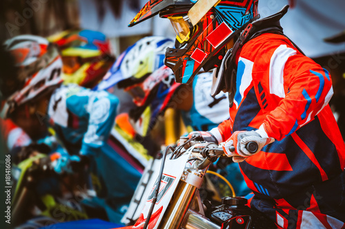 Close-up of biker sitting on motorcycle in starting point before the start of the race