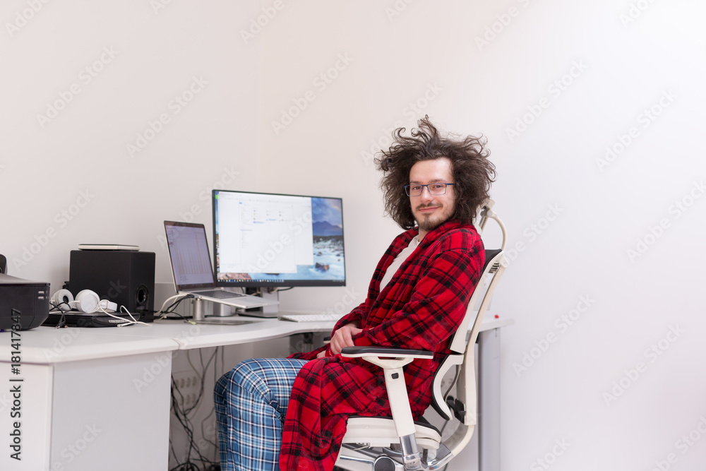 graphic designer in bathrobe working at home