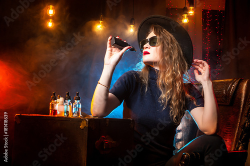 The girl smokes an electron...