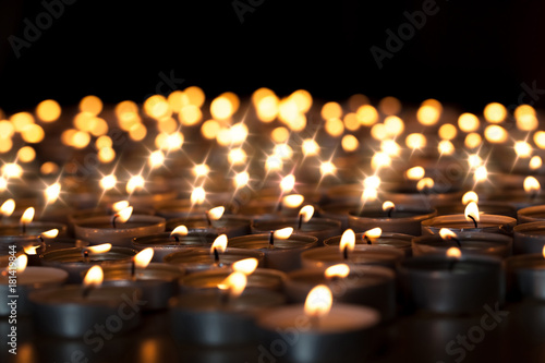 Tealight candles. Beautiful Christmas celebration, religious or remembrance candlelight image. Romantic candlelit vigil photo
