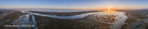 Aerial sunset seascape in Ria Formosa wetlands natural park  inland maritime channel. Algarve.