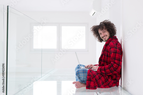 young freelancer in bathrobe working from home