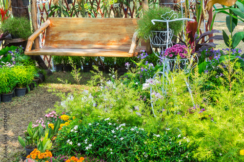 In cozy home garden./ Vintage white bike planter in cozy home flowers garden on summer. 