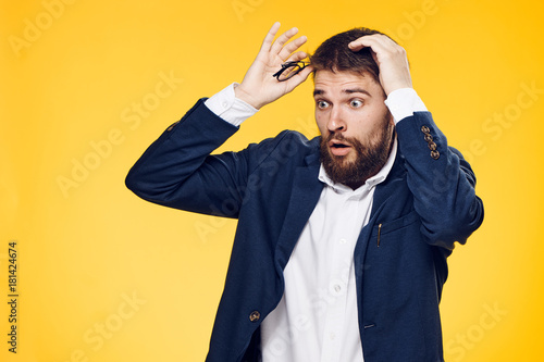 Office, business man on a yellow background, emotions, portrait