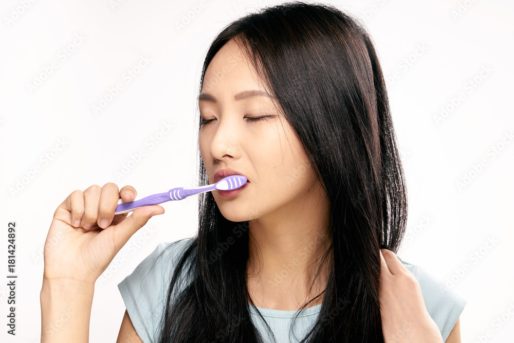 Asian, woman on white isolated background brushes teeth, toothbrush, dentistry Asian, woman on white isolated background brushes teeth, toothbrush, dentistry
