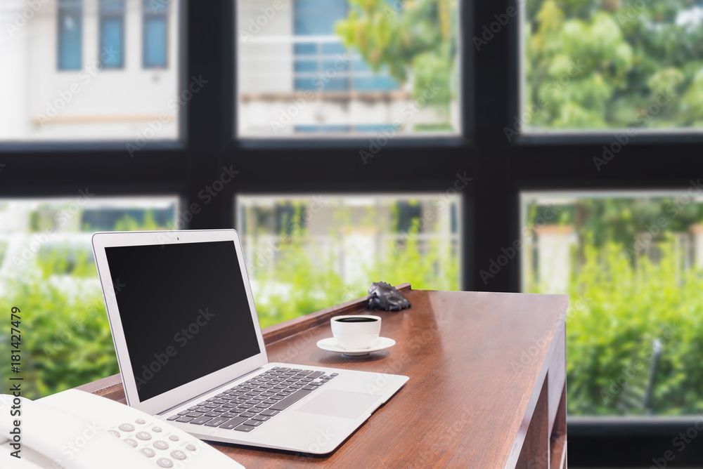 Laptops with white coffee mug on wooden desk Laptops with white coffee mug on wooden desk