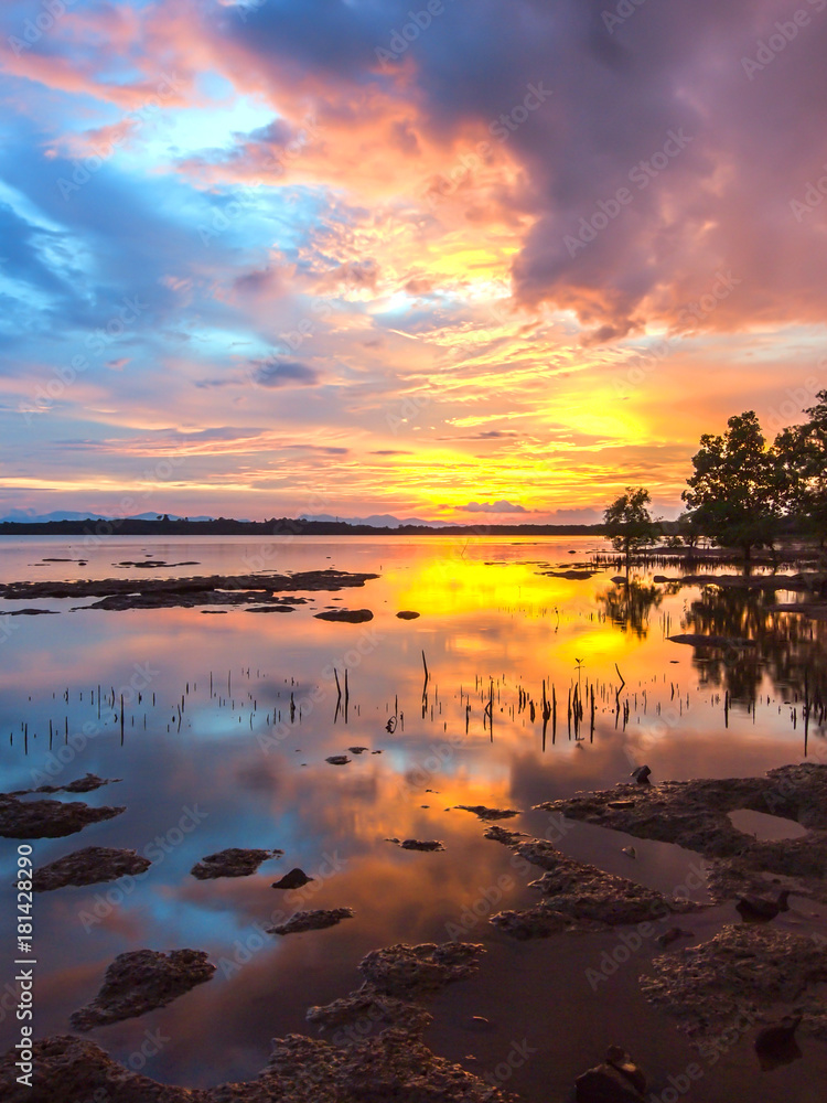 An extremely colourful sunset reflects on the still water near Ko Chang, Thailand