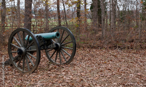 A Civil War cannon seen in the fall woods in Gettysburg, Pennsylvania