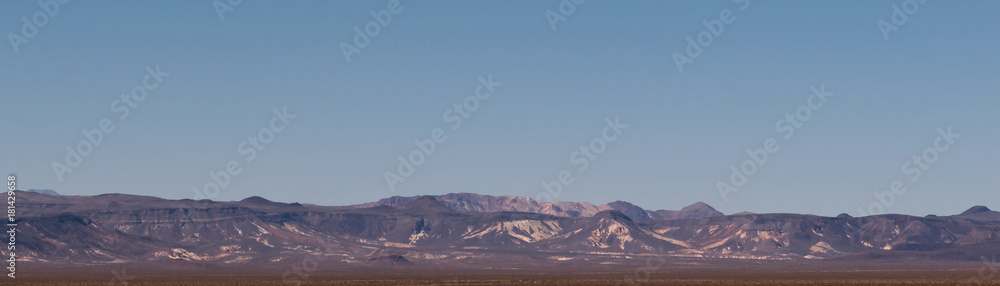 A distant mountain range with blue skies