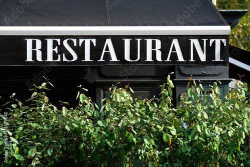Canopy of restaurant sign with bush
