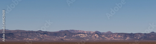 A distant mountain range with blue skies