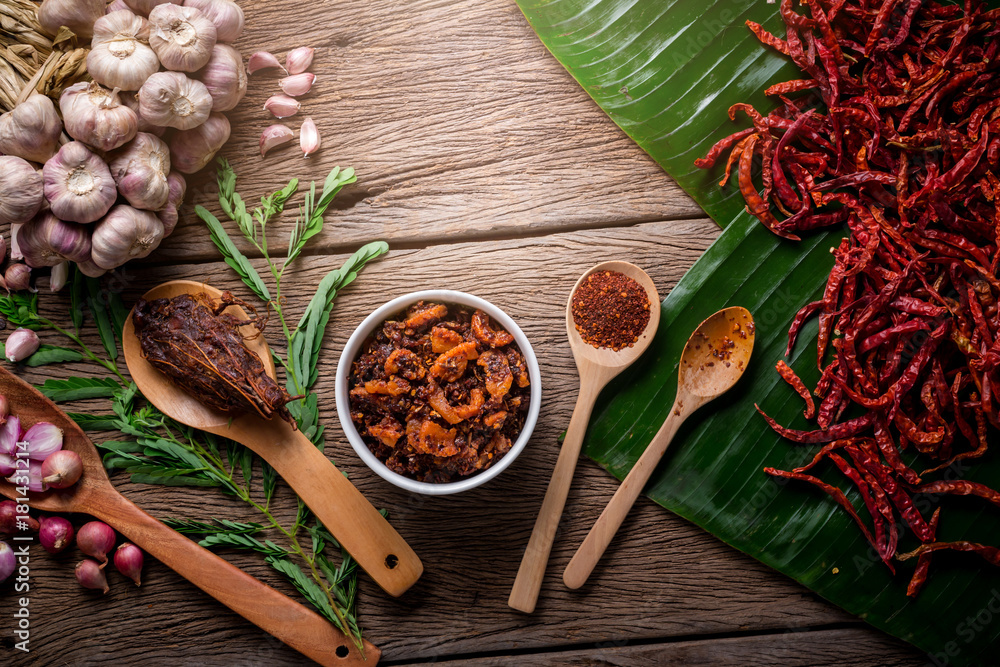 Thai tradition style spicy dipping chili paste and shrimp with spicy and herb for ingredient on wooden texture table