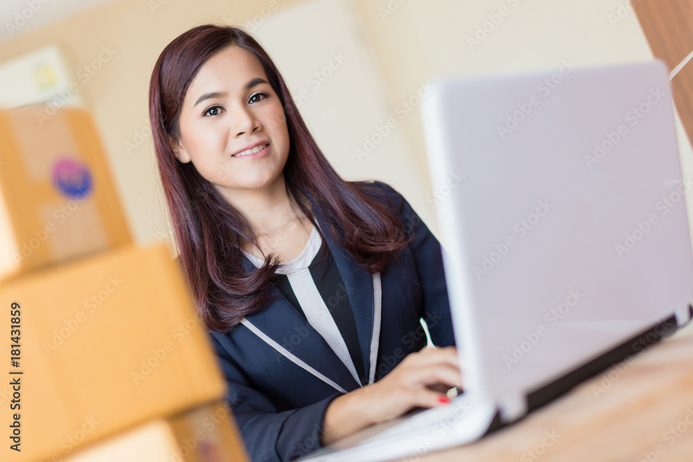 hapiness and joyful asian woman makes online shopping or selling products in a room with laptop and brown boxes of items hapiness and joyful asian woman makes online shopping or selling products in a room with laptop and brown boxes of items