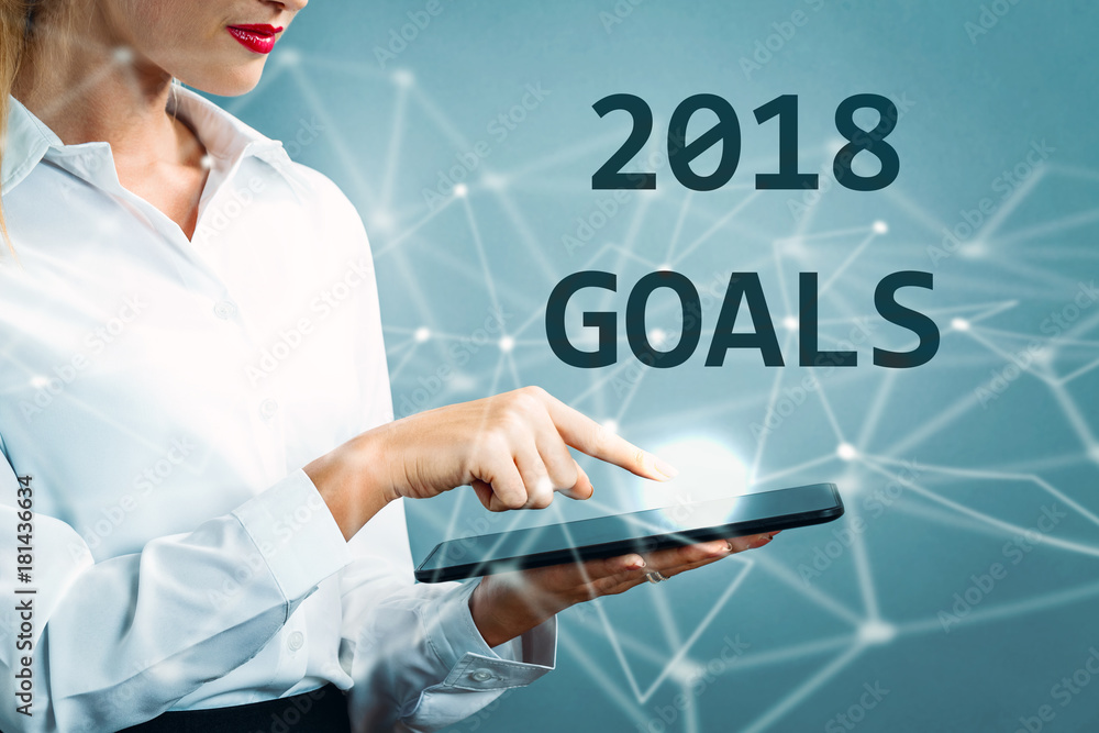 2018 Goals text with business woman using a tablet 2018 Goals text with business woman using a tablet